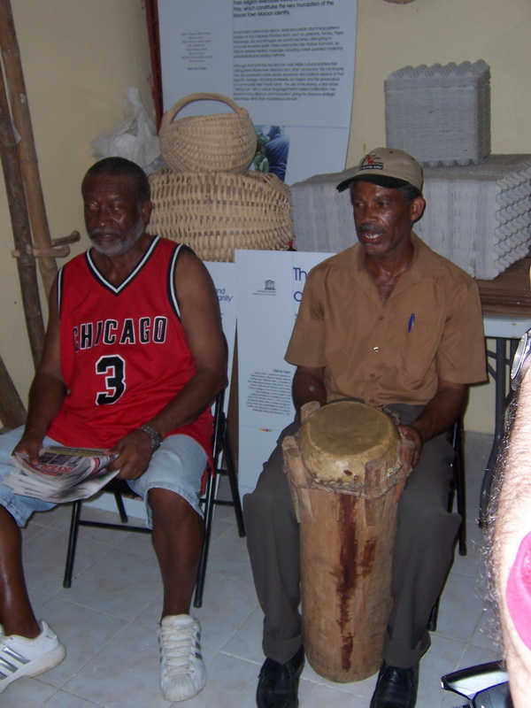 A member of the Moore Town Maroon Council sings and plays the drum